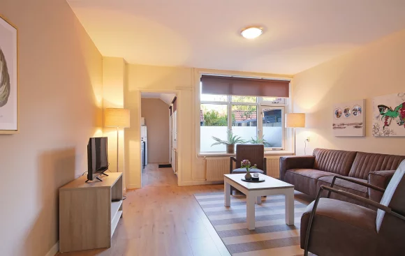 Inviting living room with a couch, coffee table, and TV