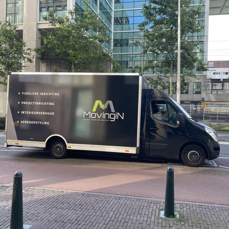 Moving-In bus in front of a building